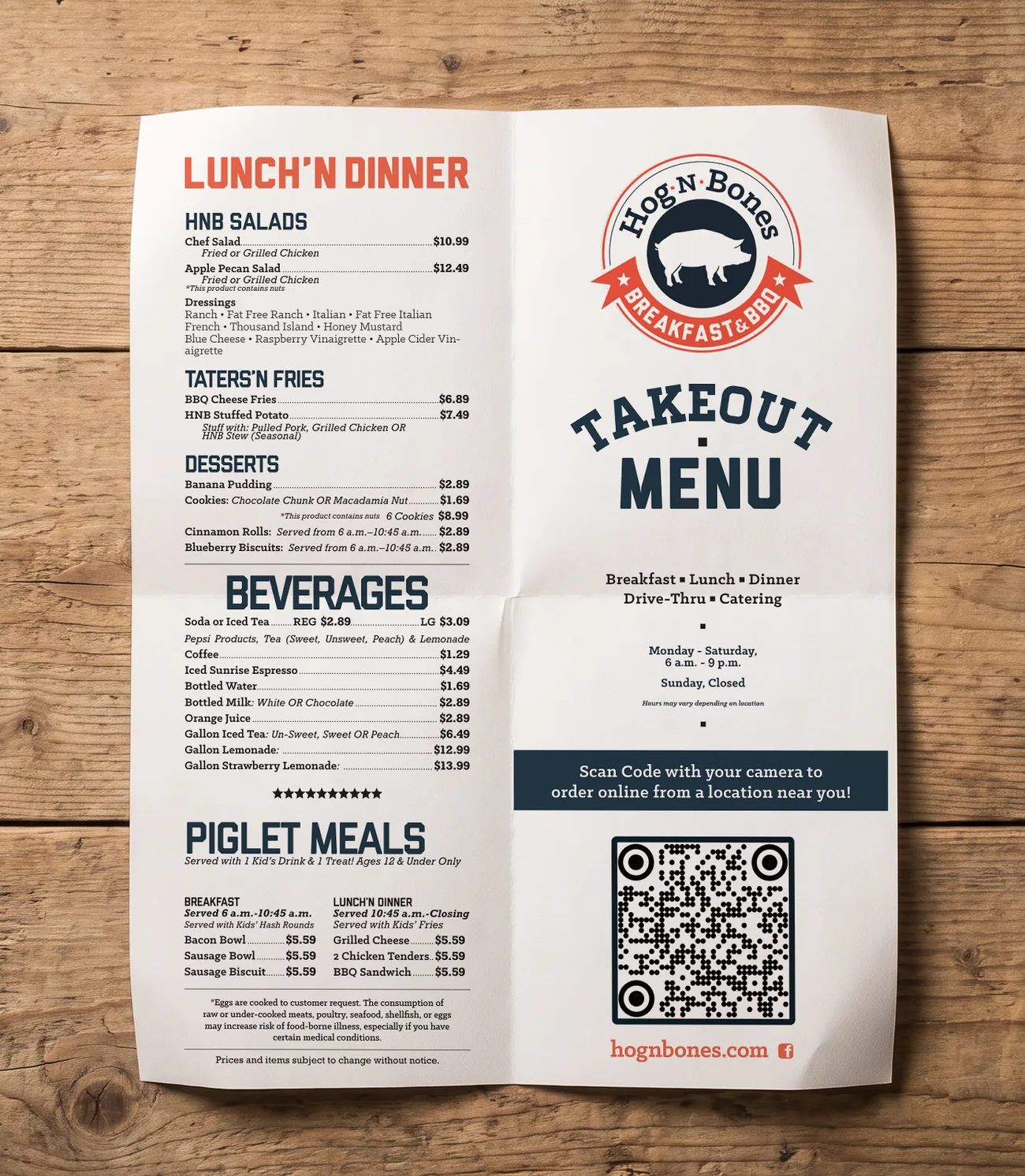 Hog-N-Bones takeout menu, printed and creased, on a wood table