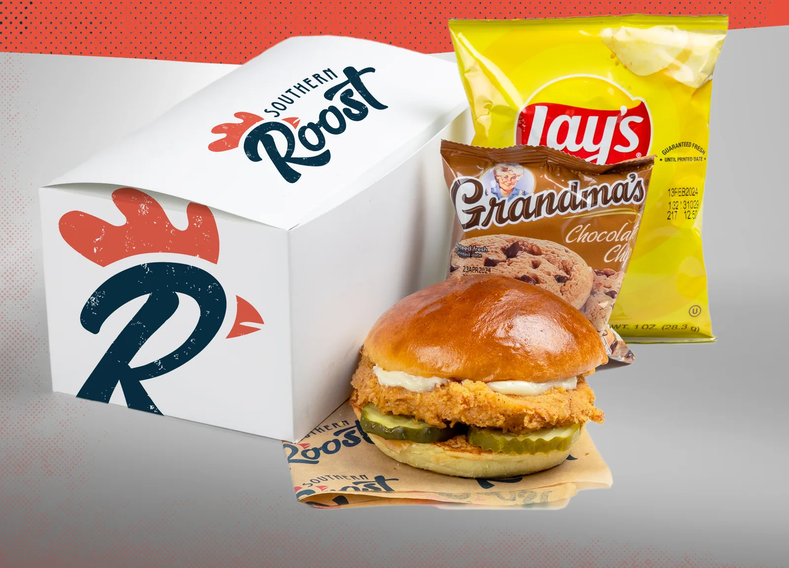 Southern Roost boxed lunch: white box with the rooster R, fried chicken sandwich, chips, and a cookie