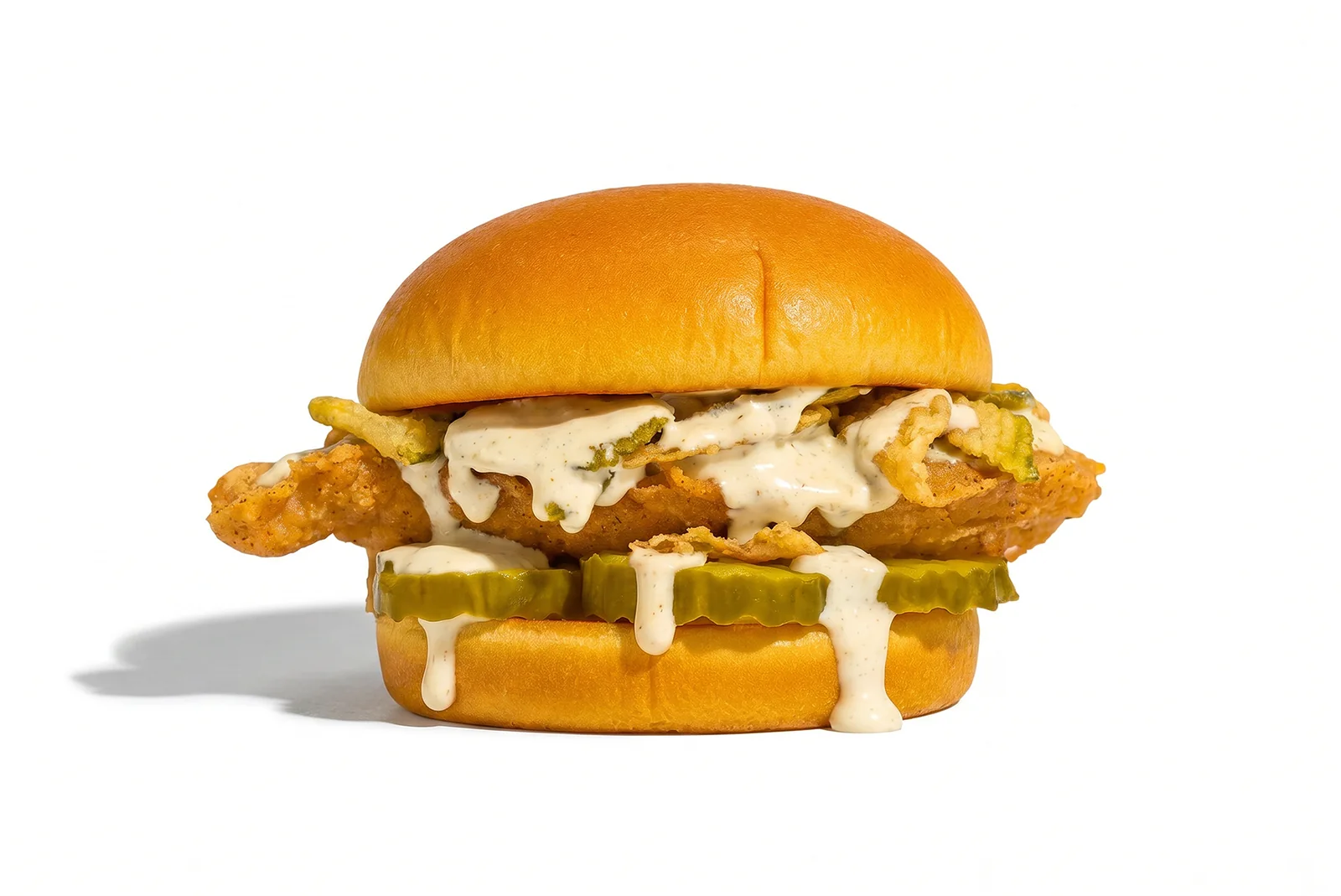 The Chickle: fried chicken sandwich with pickles and sauce, shot on white
